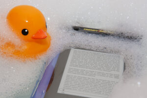 Kindle 3 floating in Trendy Digital case, with rubber duck looking on